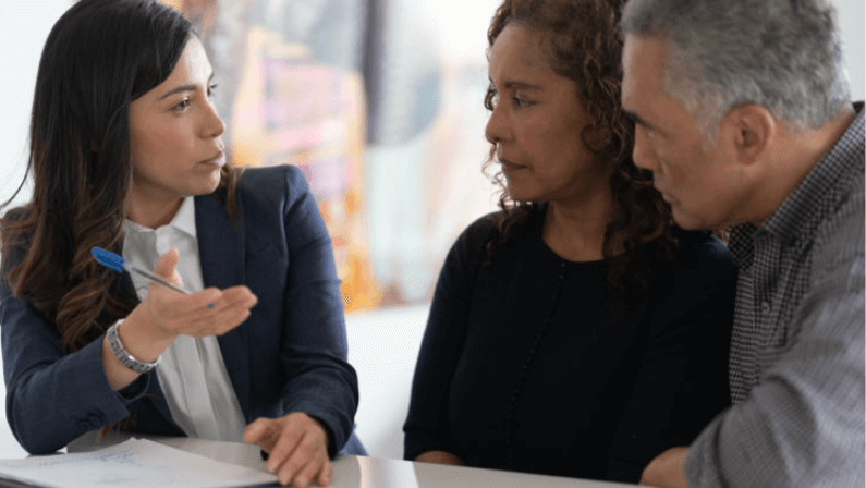 A lawyer engaged in conversation with her clients
