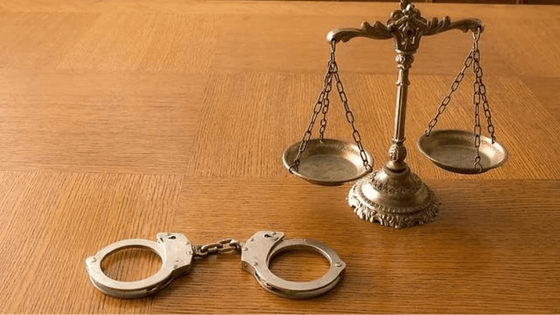 A handcuff and scale symbolizing justice and legal authority
